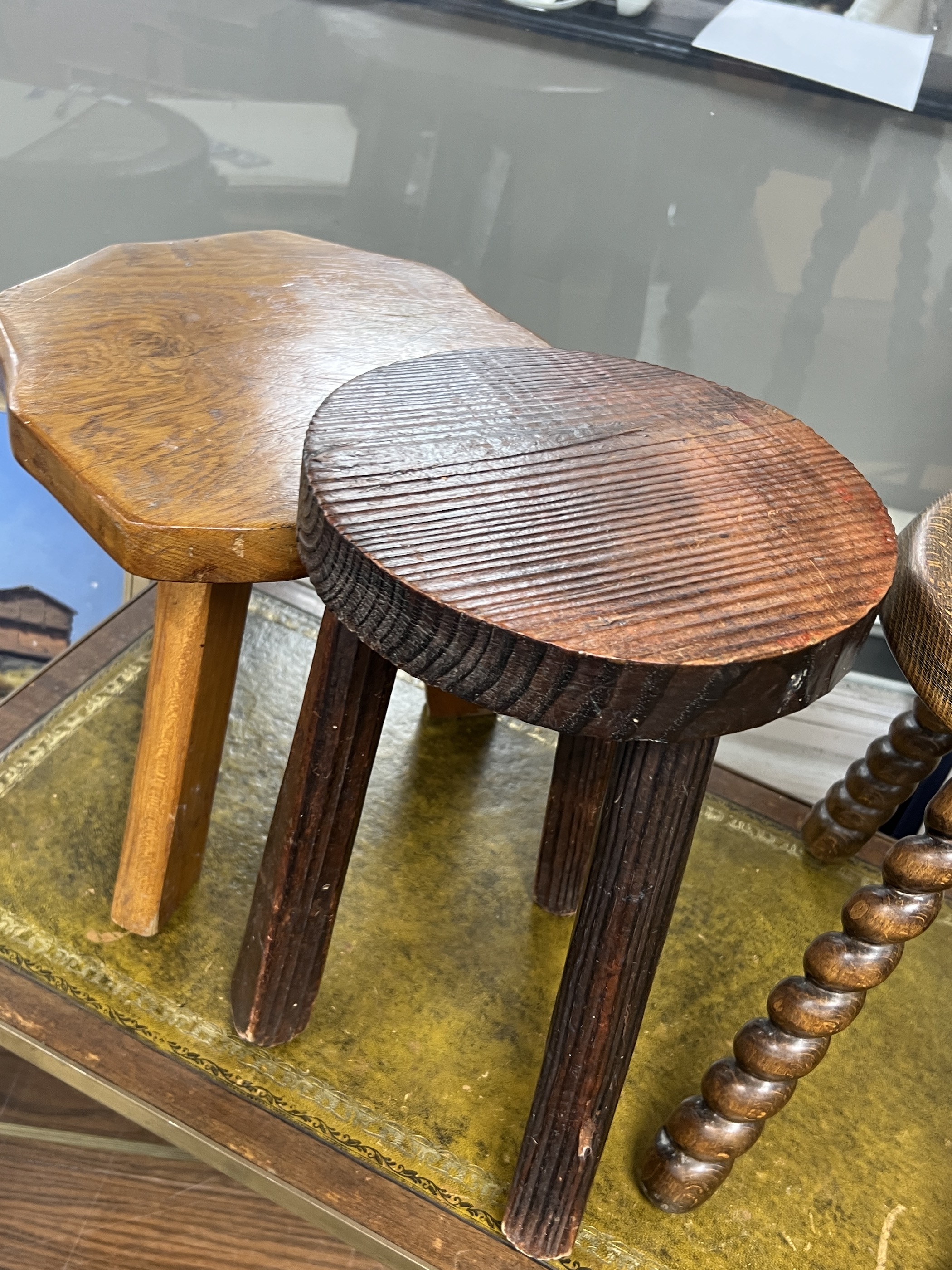 Four assorted French milking stools, largest width 24cm, height 39cm